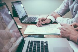 person-holding-pencil-near-laptop-computer-scaled-1